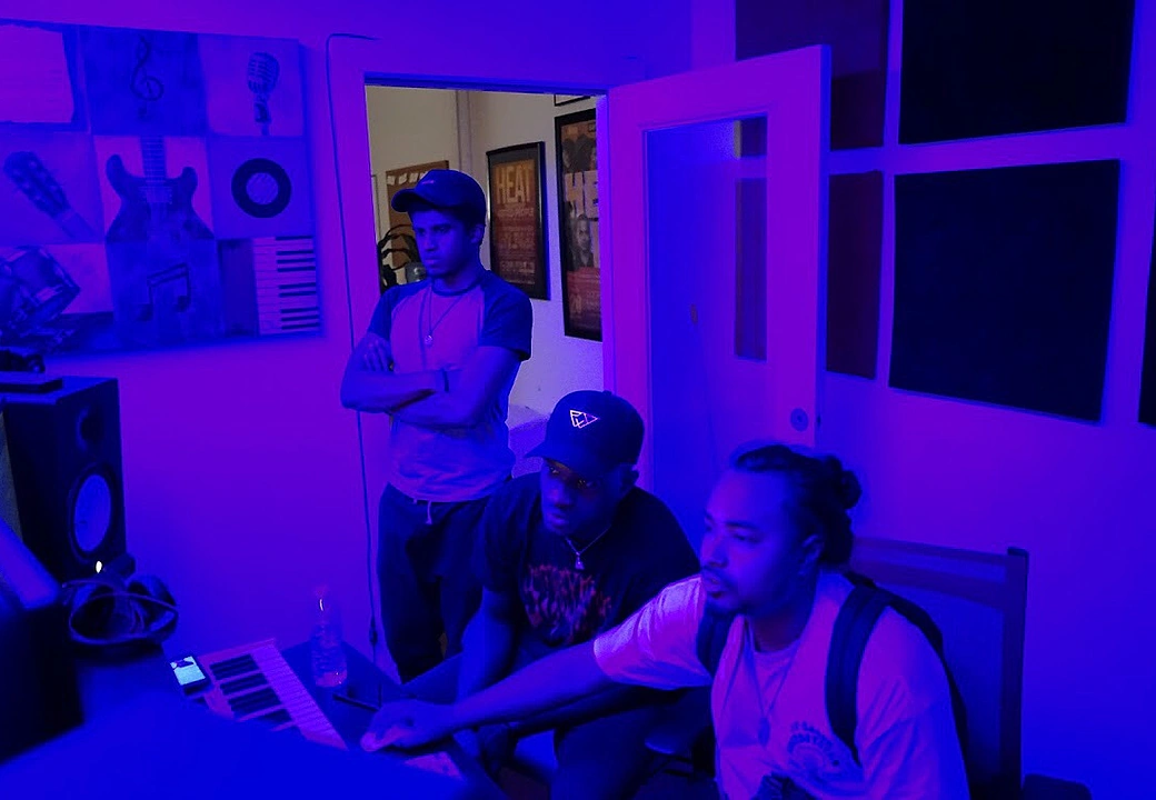Three creators collaborating at a Gifted Studios session under blue light