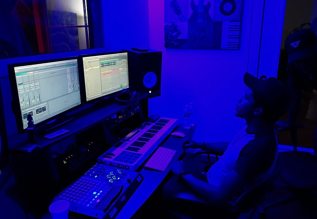A producer working the DAW and MIDI pads at Gifted Studios