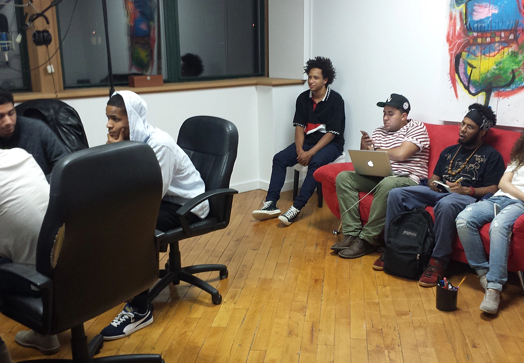 A group session in the Gifted Studios lounge with notebooks and a laptop