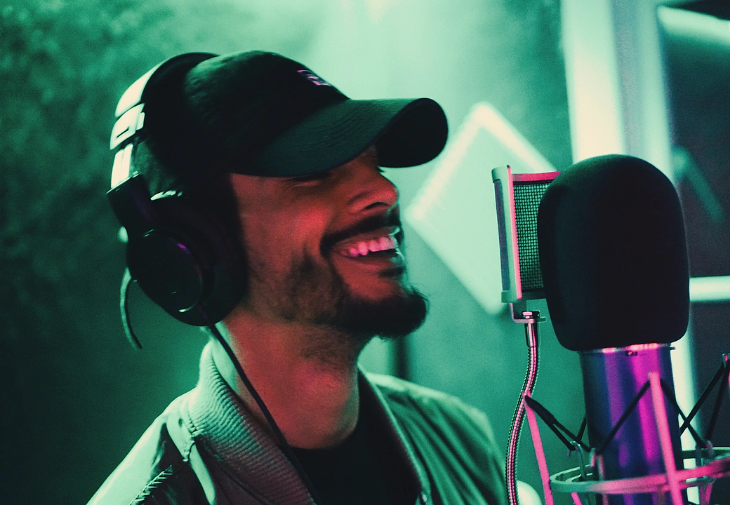 A vocalist smiling at the mic during a Gifted Studios recording session