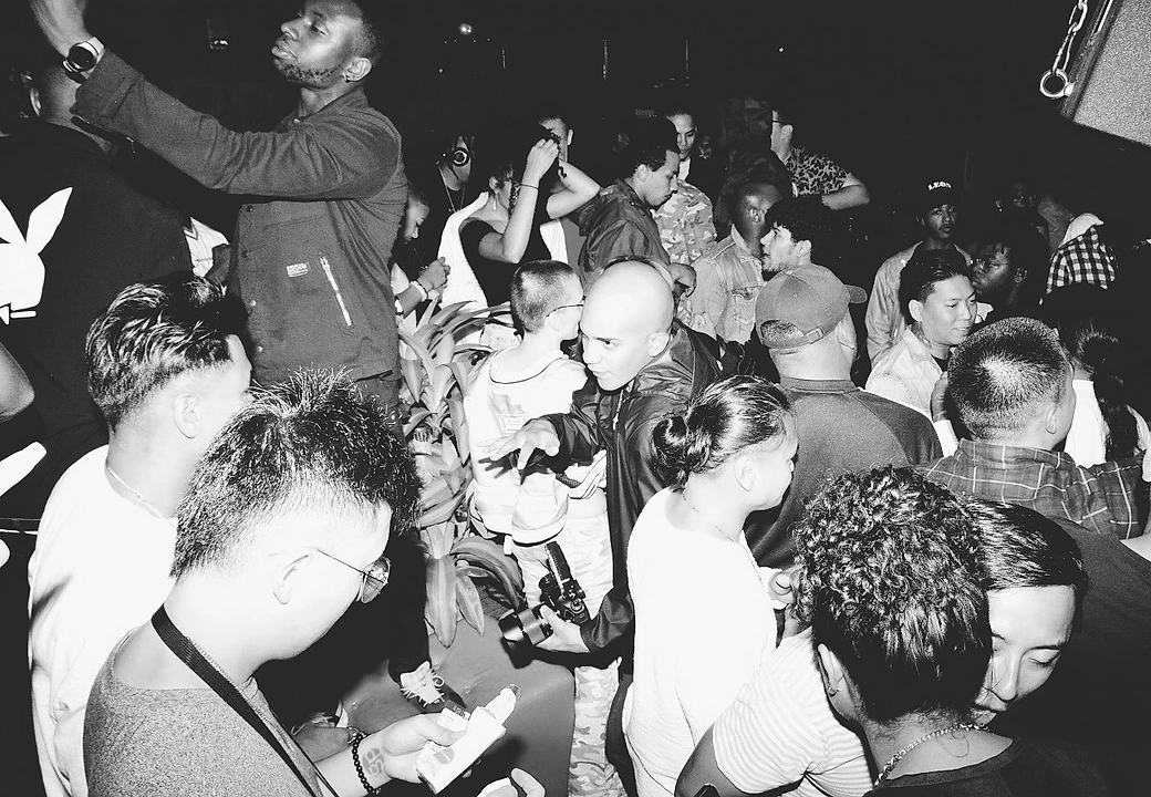 A packed room, shot in black and white, at a HEAT event