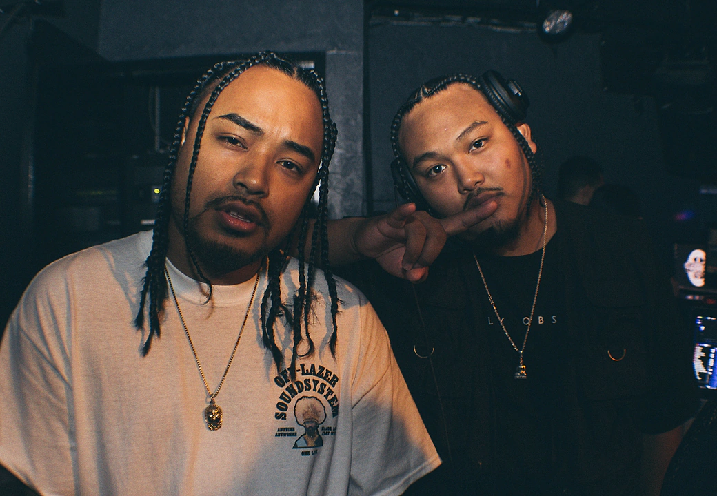 Two guys posing for the camera at a HEAT event
