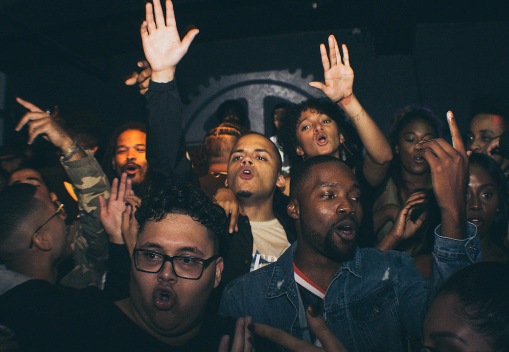 The crowd with their hands up at a HEAT event