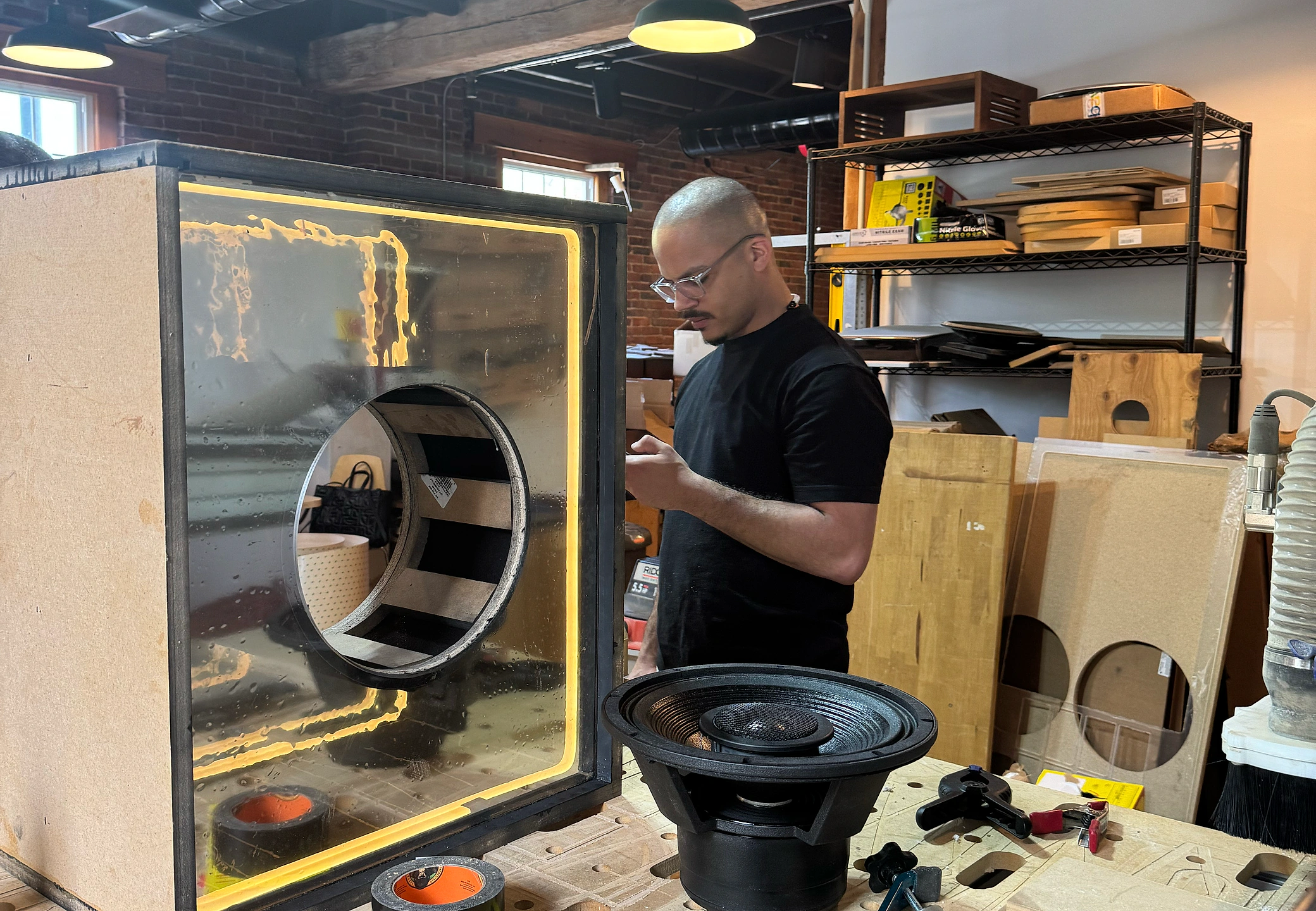 Prototype enclosure with the internal LED strip lit warm yellow on the workbench