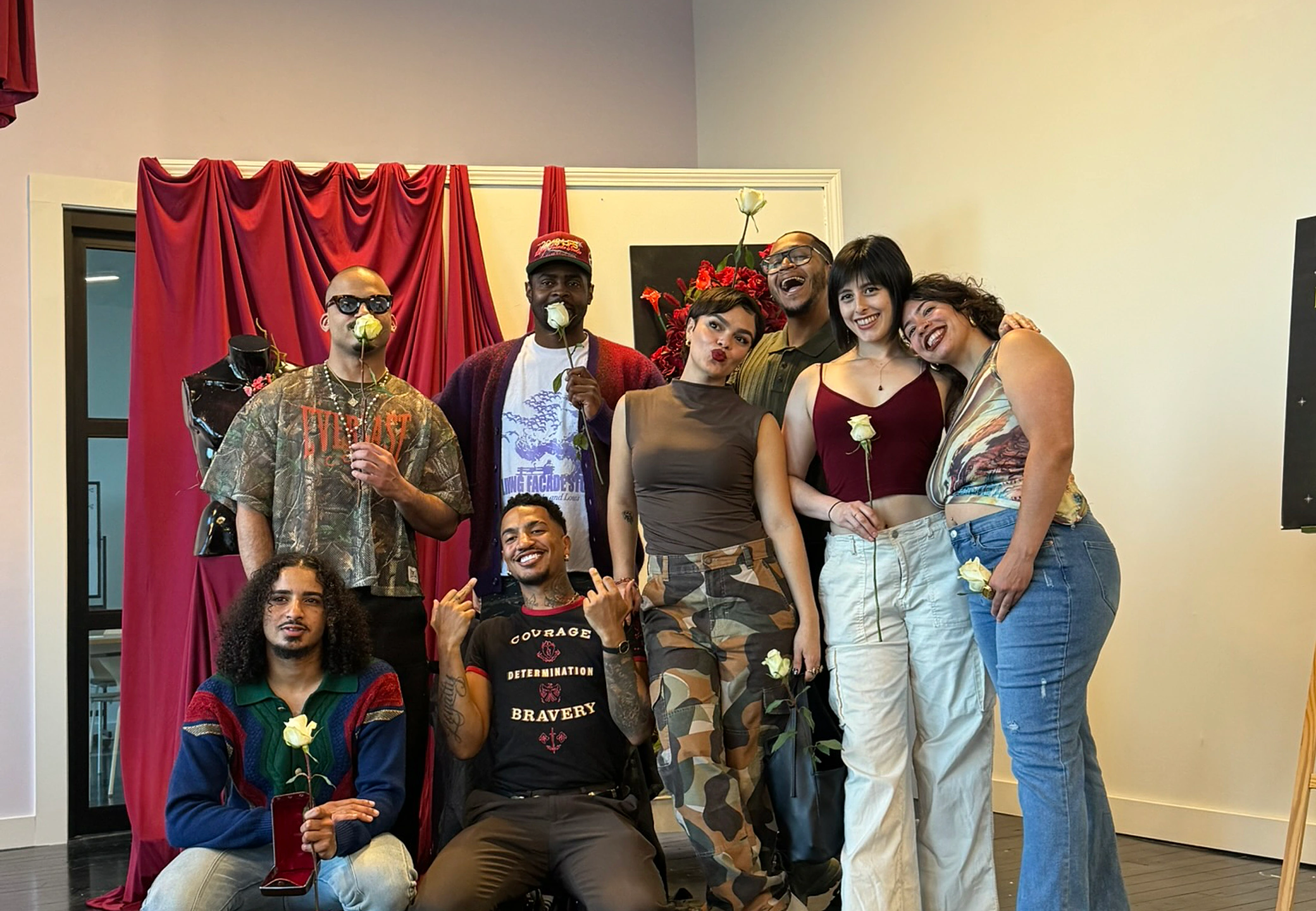 Close group shot of collaborators celebrating at the show